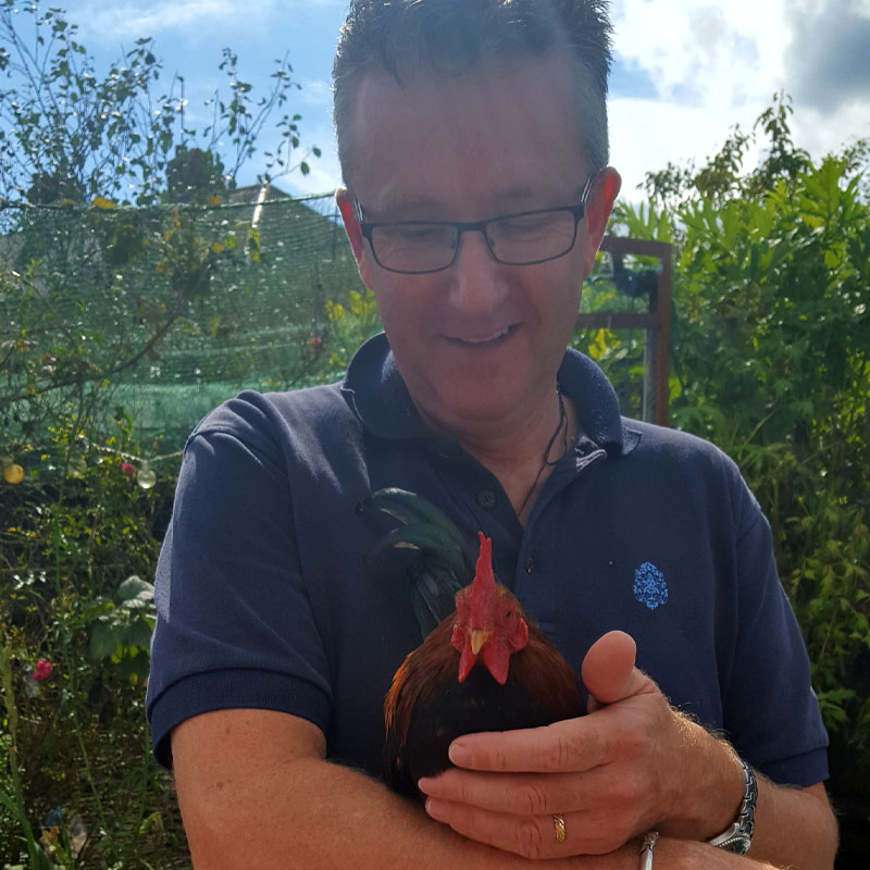 Photo of Clive Oldridge holding a rooster