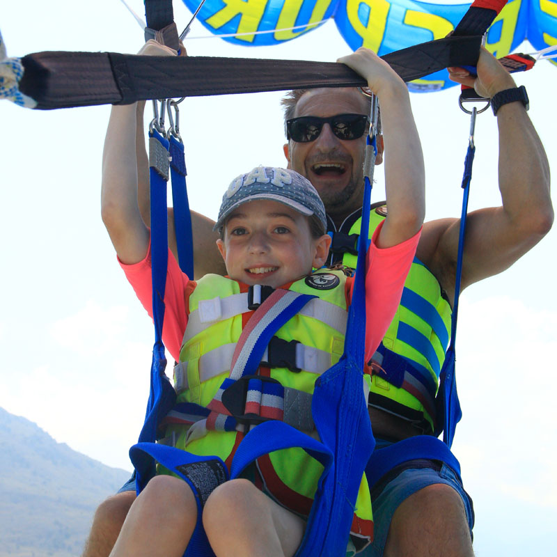 Photo of Mark Stylianou and a child parasailing
