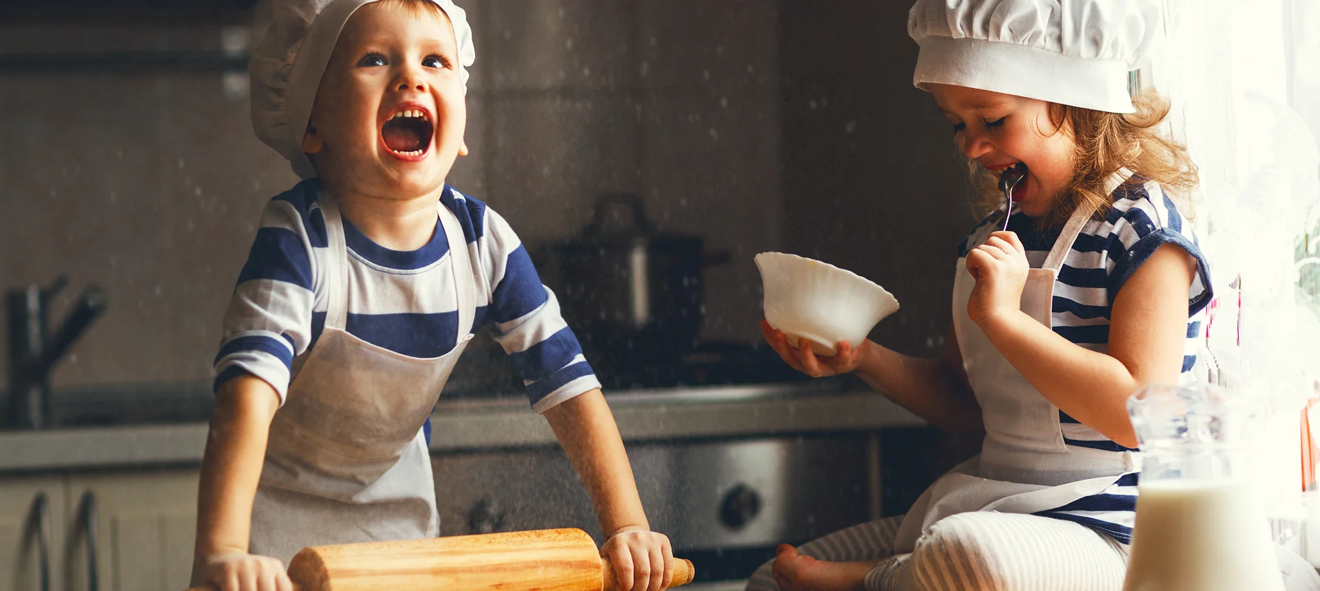 Photo of 2 young children baking