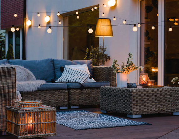 Image showing outdoor furniture setup on some decking with some lighting