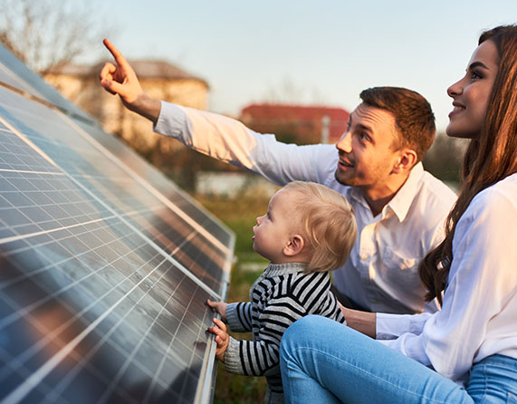 Image showing a family in front of some solar panels