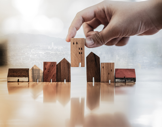Image showing a hand choosing a house made of wood