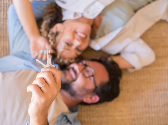 Image showing a happy couple holding a key